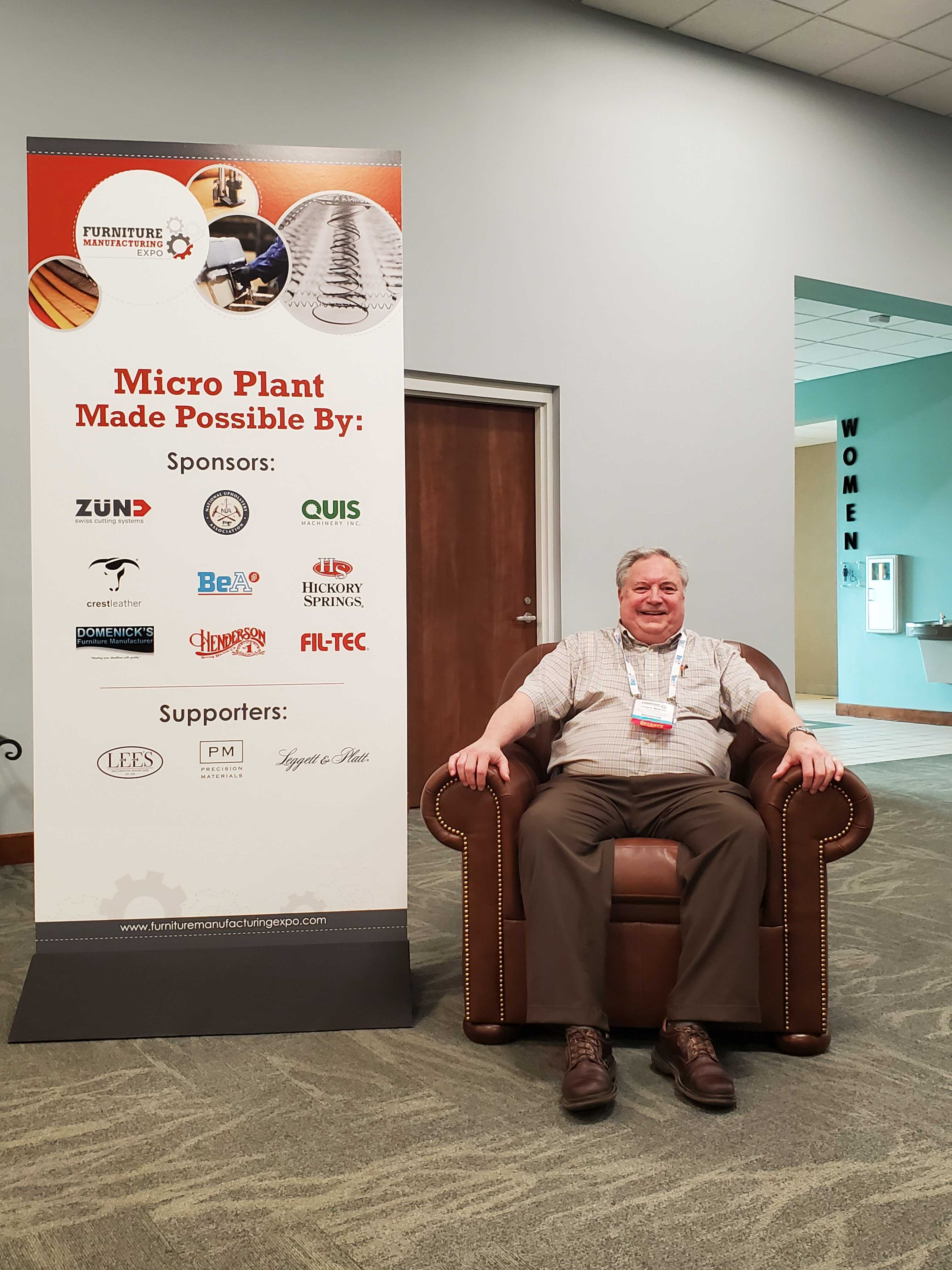 Lewis Mabon rests on a chair manufactured during the Micro Plant event